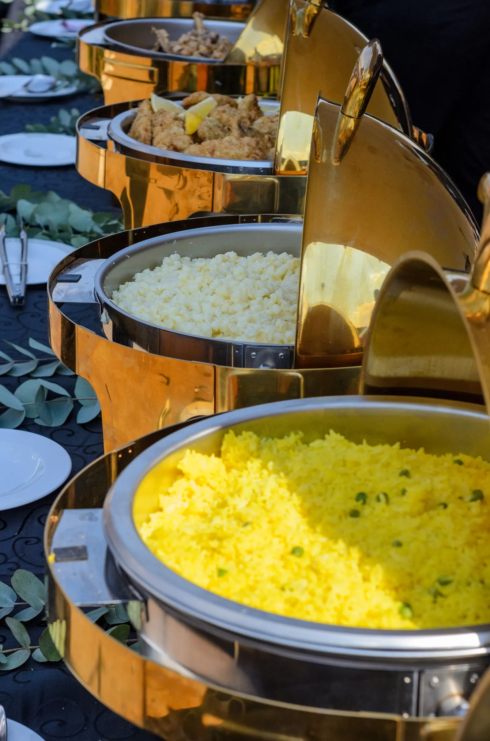 Rice and curries in chafing dishes at a catered event